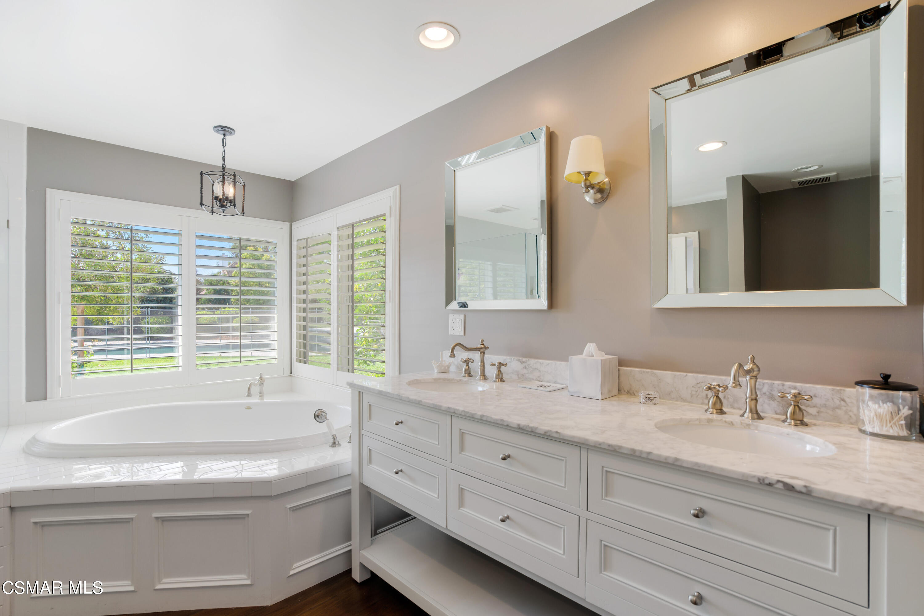 888 Rancho Road Thousand Oaks, CA 91362 - Photo 21 of 44 a bathroom with a granite countertop sink a large mirror a toilet and a bathtub