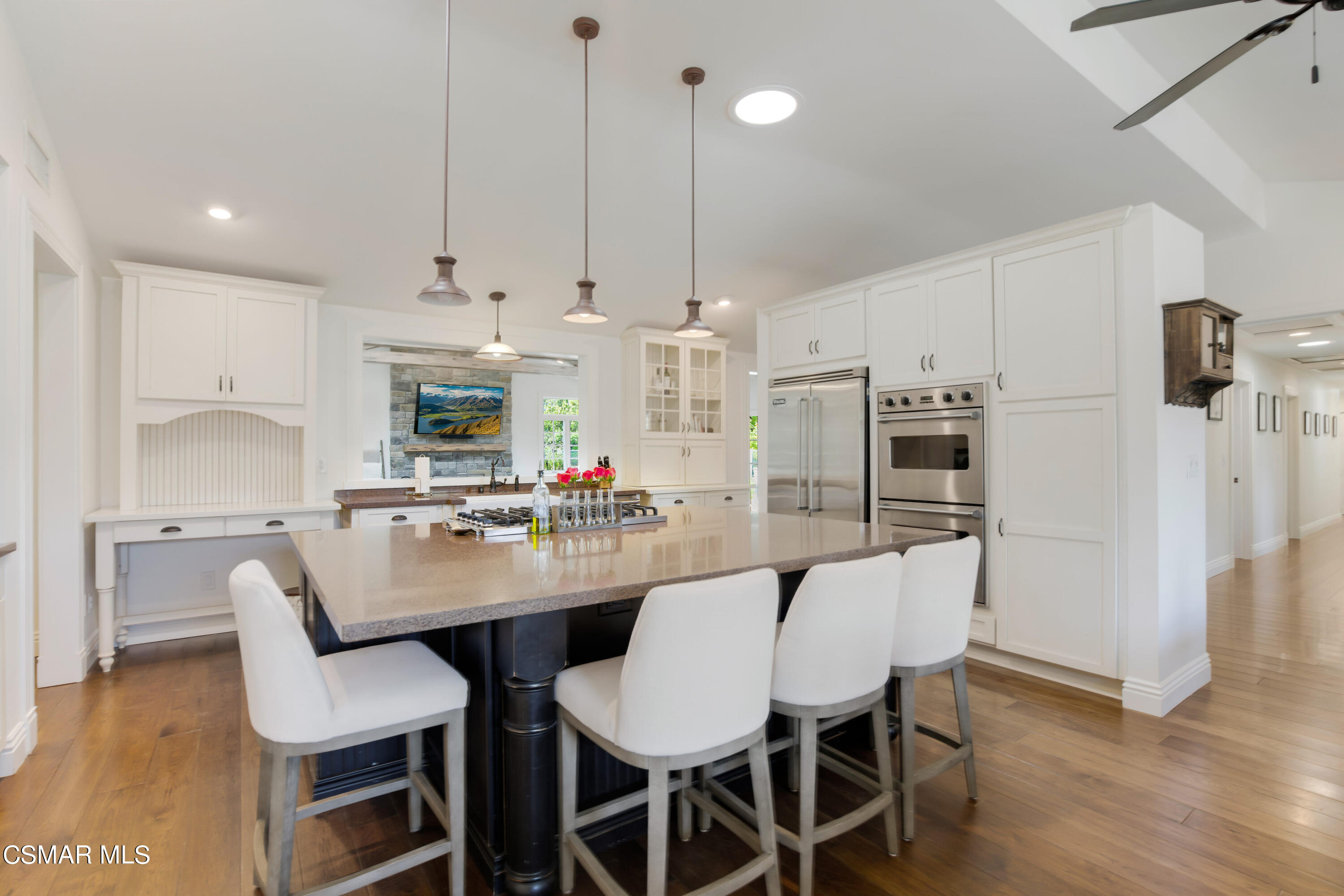 888 Rancho Road Thousand Oaks, CA 91362 - Photo 9 of 44 a kitchen with stainless steel appliances kitchen island granite countertop a dining table chairs and a refrigerator