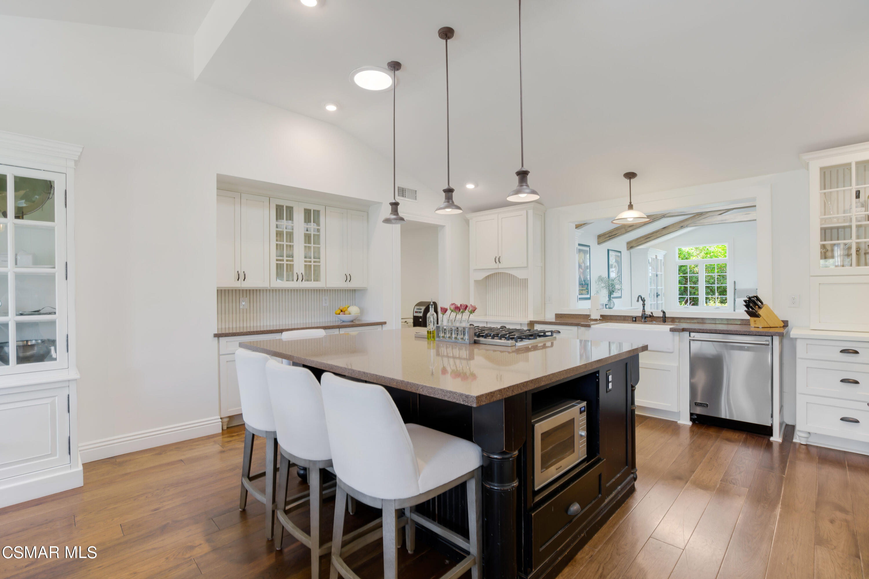 888 Rancho Road Thousand Oaks, CA 91362 - Photo 10 of 44 a kitchen with sink a center island and wooden floor