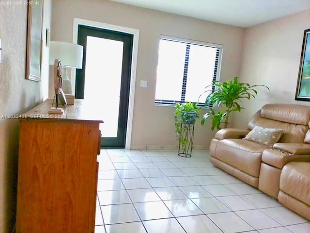 6527 West 22nd Lane Hialeah, FL 33016 - Photo 2 of 18 a living room with a couch and a potted plant