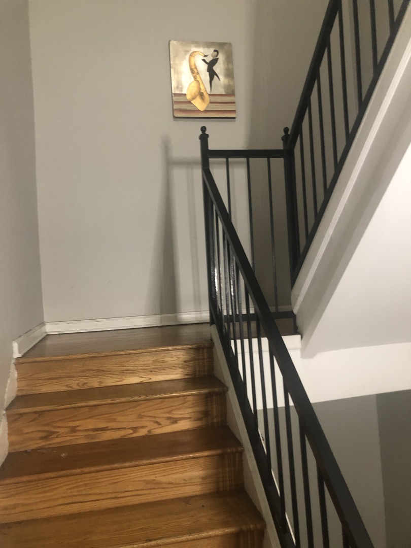 4407 West Adams Street Chicago, IL 60624 - Photo 9 of 10 a view of staircase with wooden floor and a potted plant