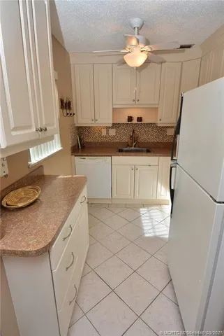 a kitchen with granite countertop cabinets a sink and a stove