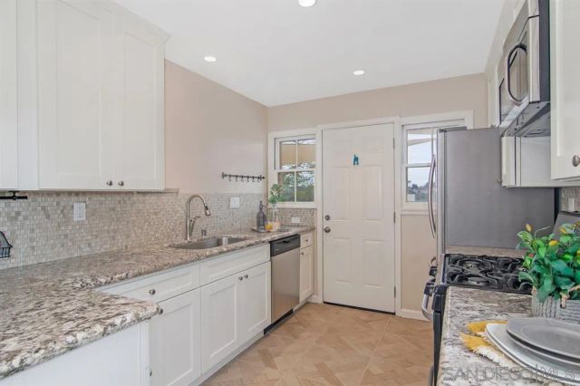 a kitchen with a sink and a refrigerator
