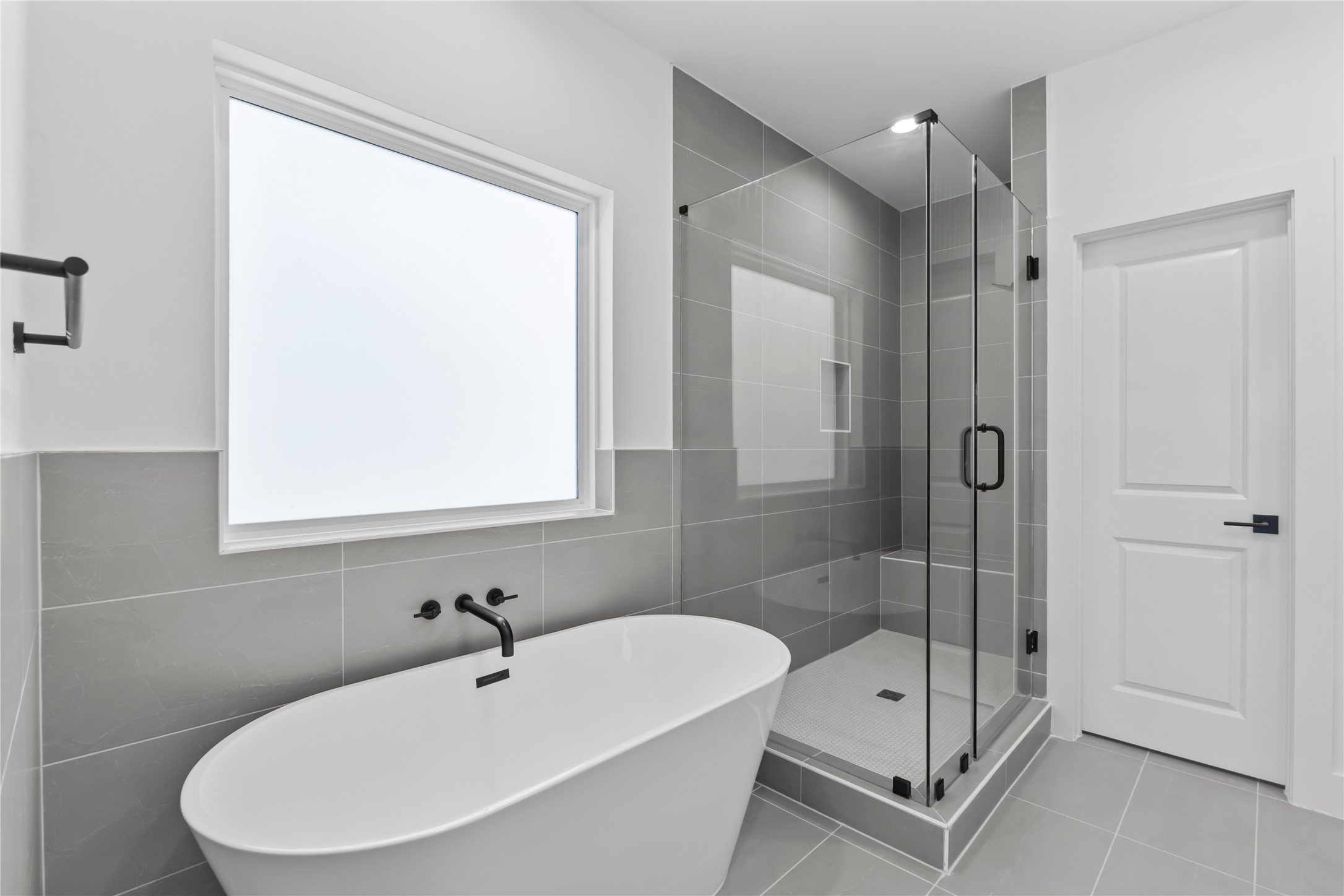 3426 Bolin Road Houston, TX 77092 - Photo 23 of 34 Spa-inspired master bath with a sleek freestanding tub and glass-enclosed shower.