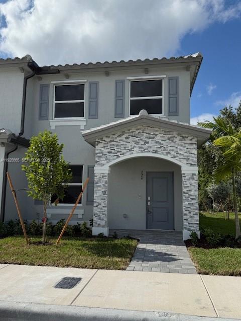 2763 Southeast 26th Road, Unit 2763 Homestead, FL 33035 - Photo 15 of 16 a front view of a house with garden