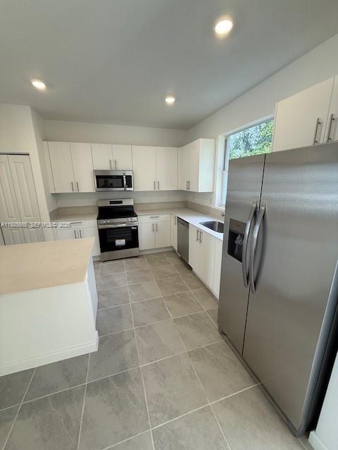 2763 Southeast 26th Road, Unit 2763 Homestead, FL 33035 - Photo 3 of 16 a kitchen with kitchen island granite countertop a sink a counter top space and cabinets
