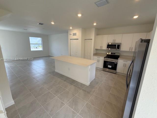 2763 Southeast 26th Road, Unit 2763 Homestead, FL 33035 - Photo 4 of 16 a large white kitchen with a refrigerator a stove a microwave and a sink