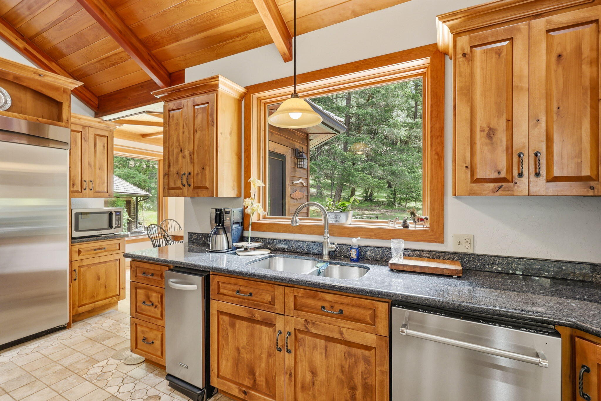 985 Elliott Creek Road Wilderville, OR 97543 - Photo 15 of 98 a kitchen with stainless steel appliances granite countertop a sink a counter top space and cabinets