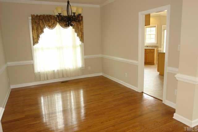 11623 Shavenrock Place Raleigh, NC 27613 - Photo 3 of 10 a view of empty room with wooden floor and fan