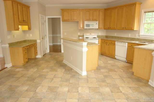 11623 Shavenrock Place Raleigh, NC 27613 - Photo 5 of 10 a kitchen with a stove a sink dishwasher a refrigerator and cabinets
