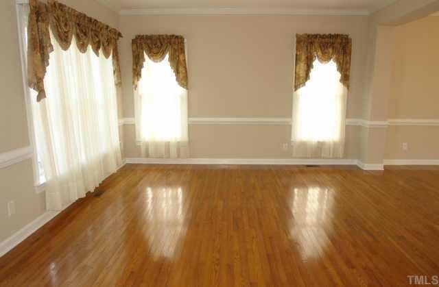 11623 Shavenrock Place Raleigh, NC 27613 - Photo 9 of 10 a view of empty room with wooden floor and fan