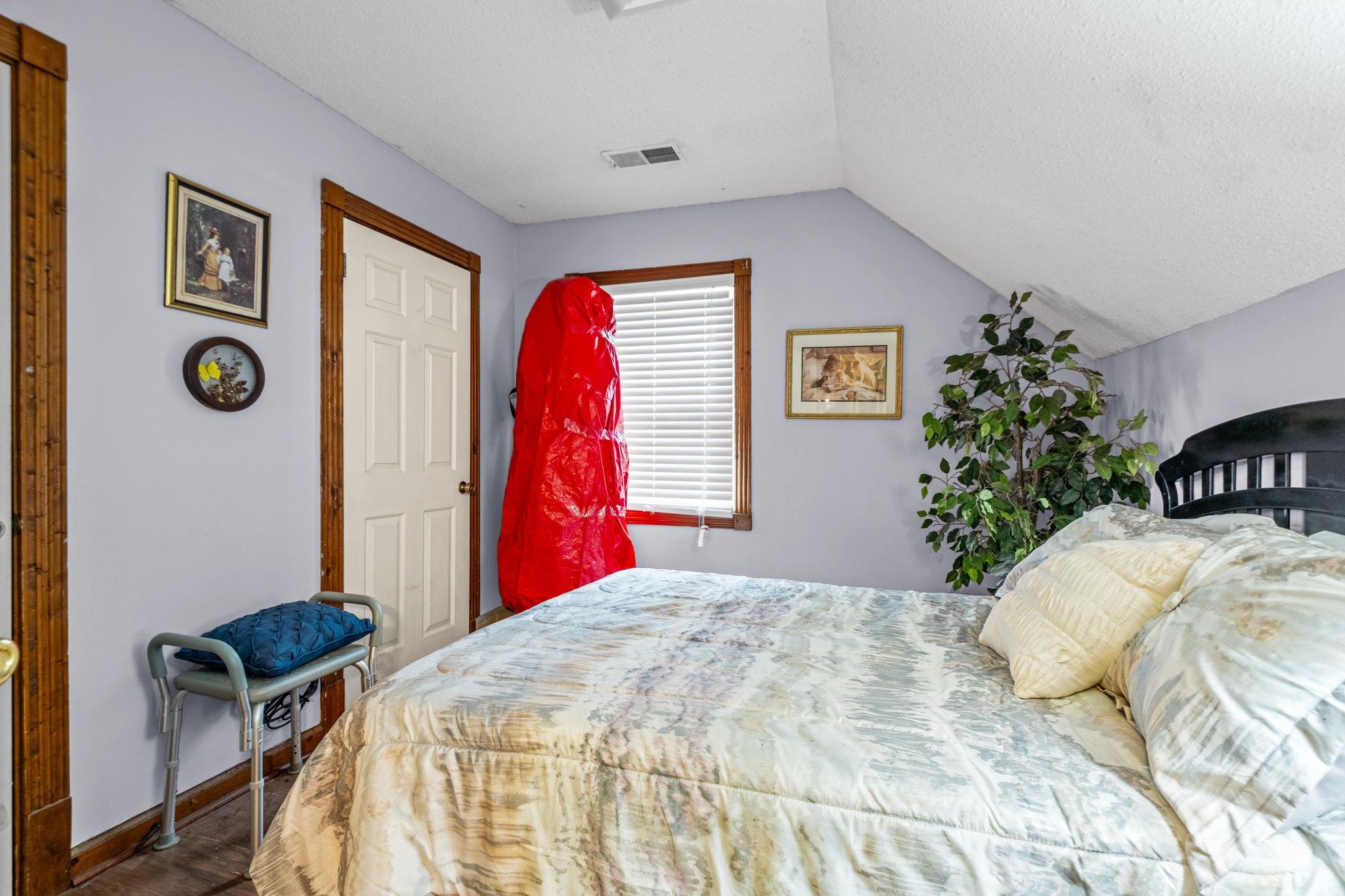 4572 Benoit Drive Memphis, TN 38141 - Photo 17 of 25 a bed room with a bed and a chair