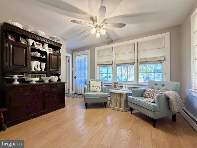 a living room with furniture and large windows