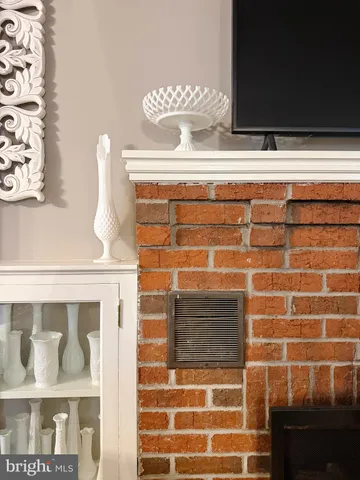 a living room with furniture and view of kitchen