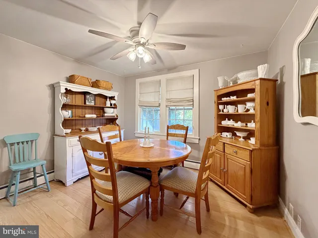 a view of a hallway with bathroom and wooden floor