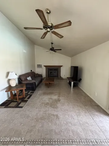 a view of a livingroom with a fireplace and a window