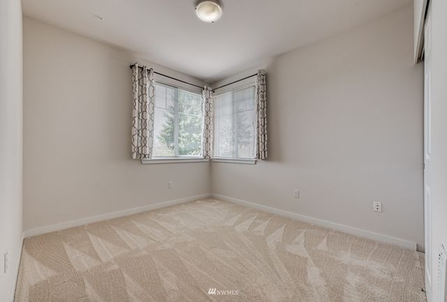 a bedroom with a bed chair and a window