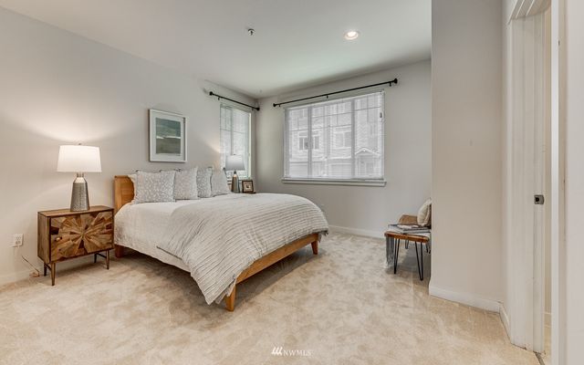 a bathroom with a double vanity sink toilet and a mirror