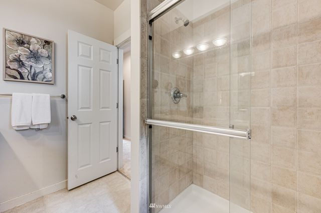 a view of a patio with a table and chairs and wooden fence