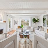 a living room with furniture fireplace and a large window