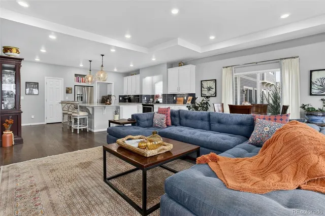 a living room with furniture and wooden floor