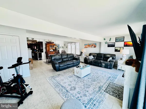 a living room with furniture window and a flat screen tv