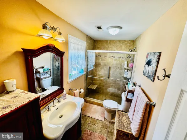 a bathroom with a sink mirror vanity and toilet