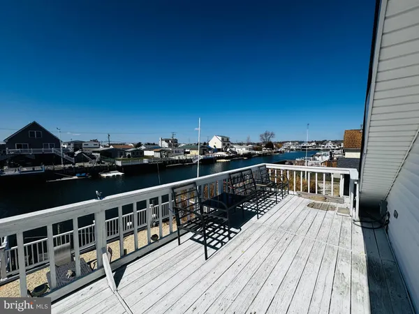 a balcony with wooden floor and city view