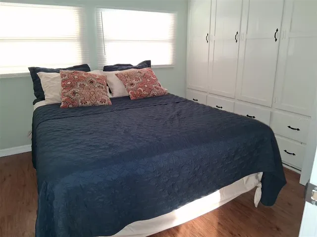 a bed sitting in a bedroom next to a window