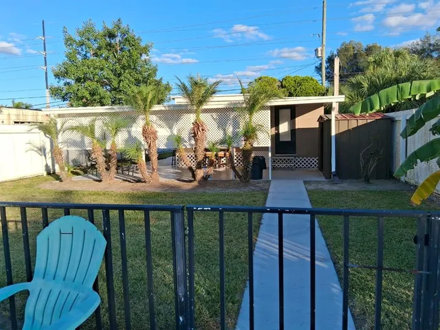 a view of a house with backyard and porch