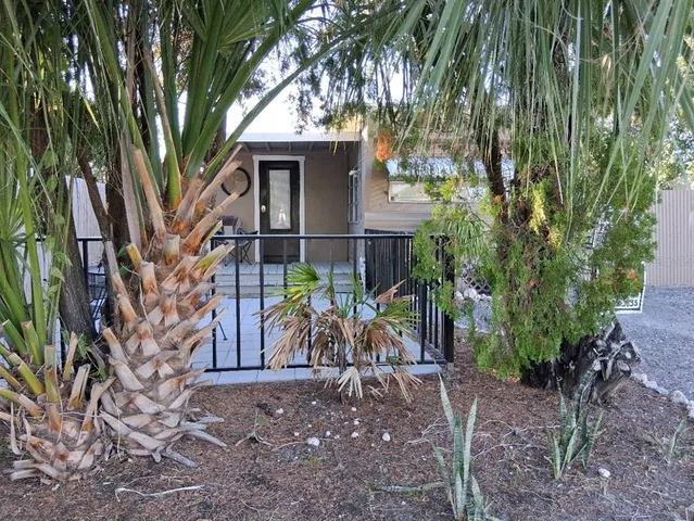 a view of a wooden house with a tree