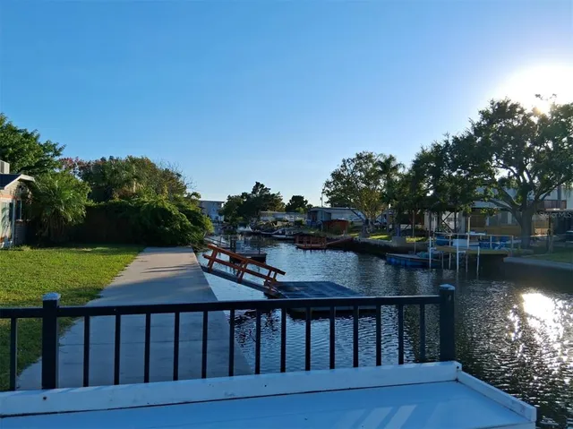 a balcony with wooden floor and yard