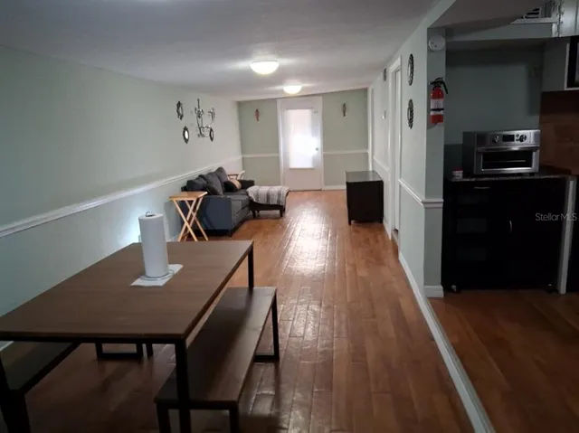 a view of a dining room with furniture and wooden floor