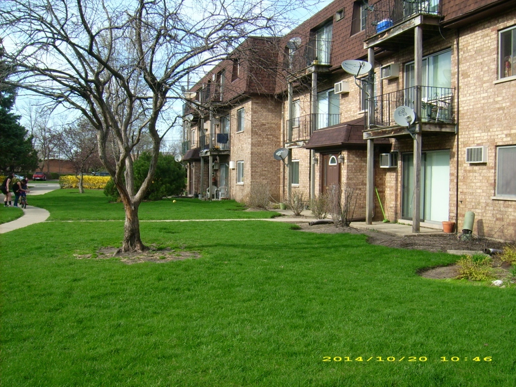 115 East Dundee Road, Unit 1S Wheeling, IL 60090 - Photo 2 of 12 a view of a building with a yard