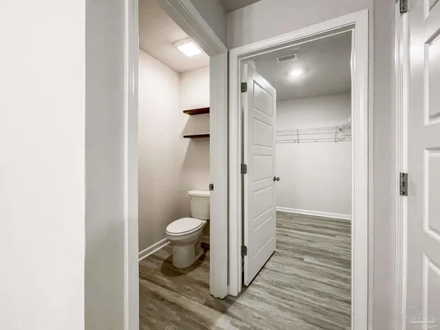 a bathroom with a granite countertop toilet and a shower