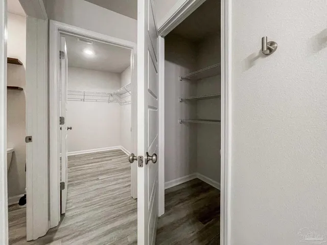 a view of a room with wooden floor