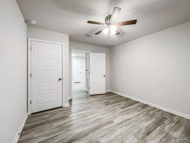a view of hallway with wooden floor