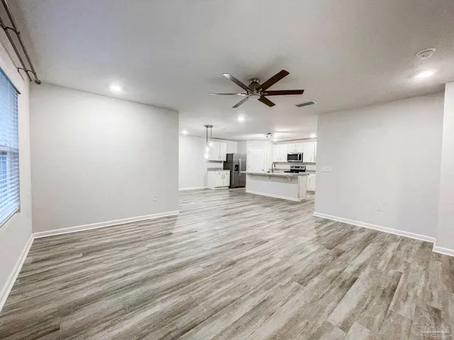 a view of a kitchen with a sink and a refrigerator