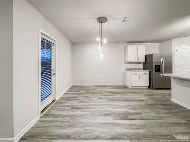 a view of a kitchen with a stove cabinets and wooden floor