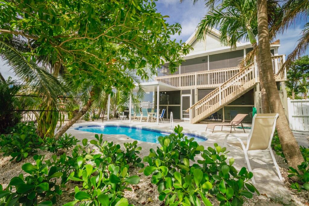 497 Sombrero Beach Road Marathon, FL 33050 - Photo 1 of 33 a view of house with swimming pool and sitting area