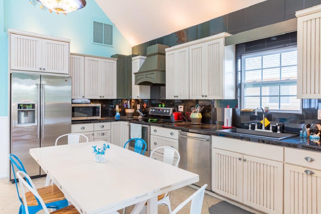 497 Sombrero Beach Road Marathon, FL 33050 - Photo 11 of 33 a kitchen with stainless steel appliances a sink a microwave a refrigerator and a stove