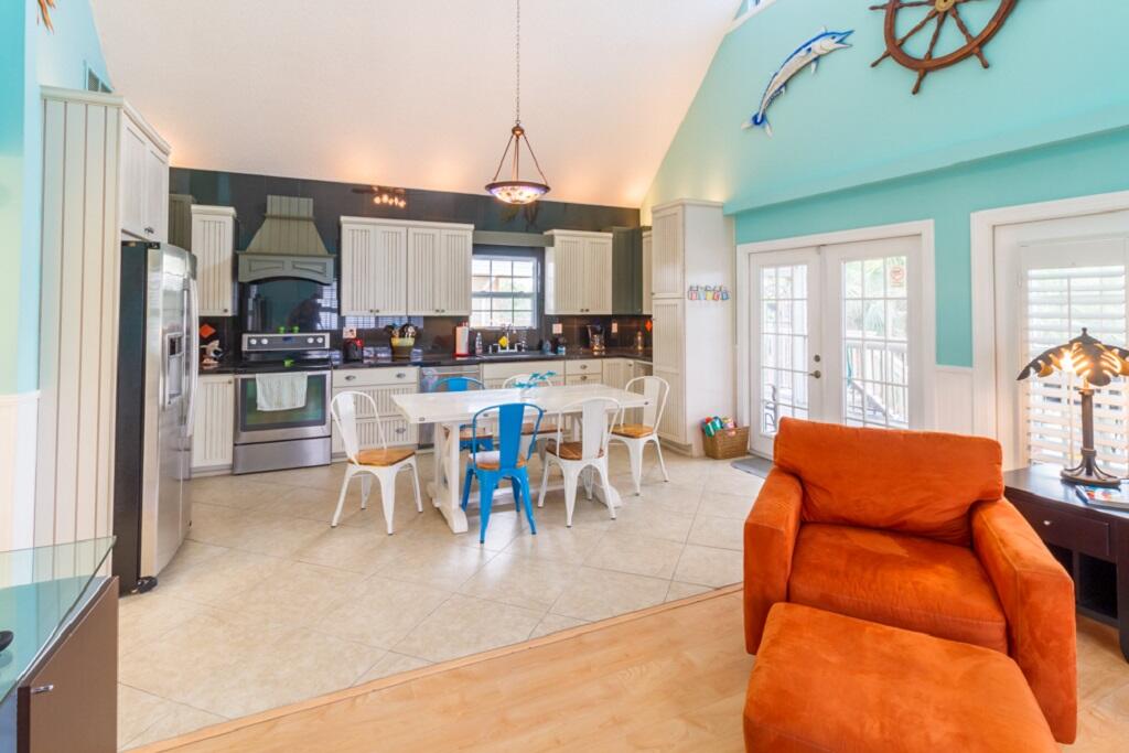497 Sombrero Beach Road Marathon, FL 33050 - Photo 12 of 33 a dining hall with stainless steel appliances granite countertop a table chairs and a view of living room