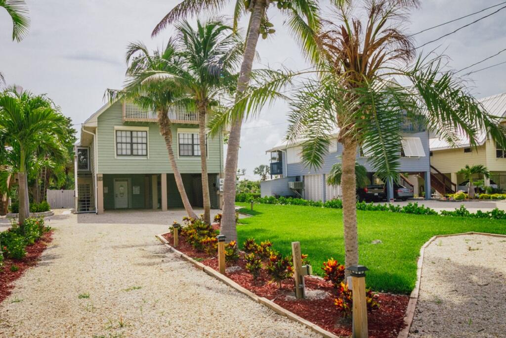 497 Sombrero Beach Road Marathon, FL 33050 - Photo 2 of 33 a front view of a house with garden and trees