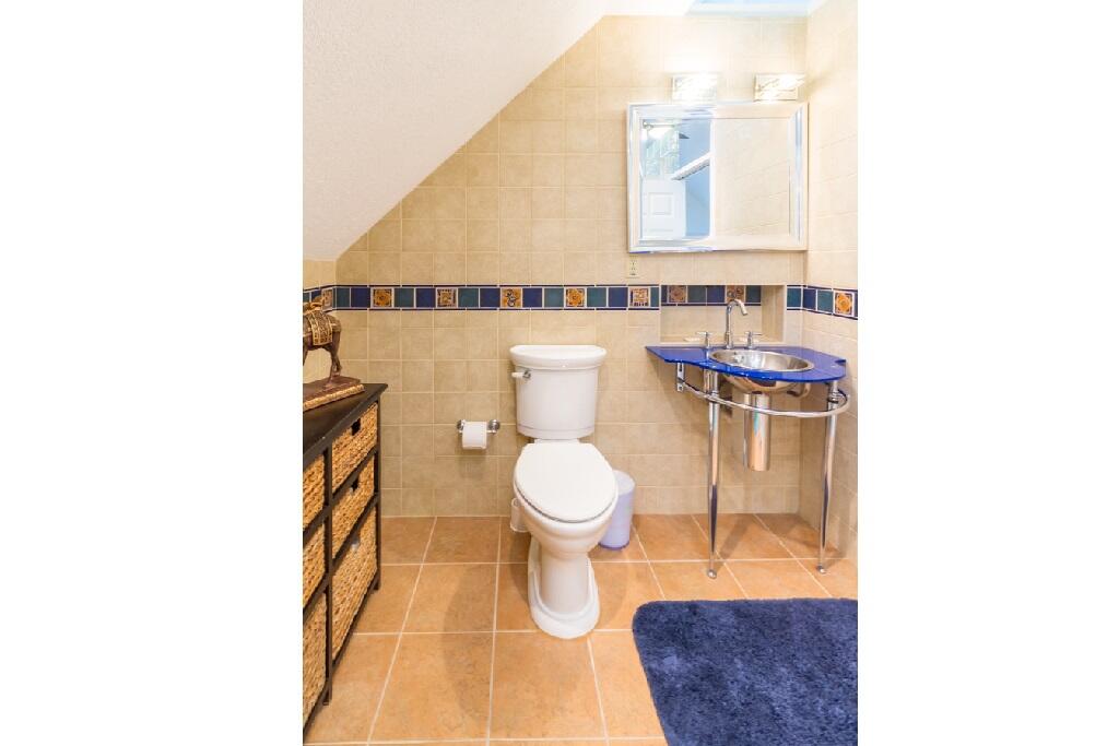 497 Sombrero Beach Road Marathon, FL 33050 - Photo 24 of 33 a bathroom with a toilet a sink and mirror