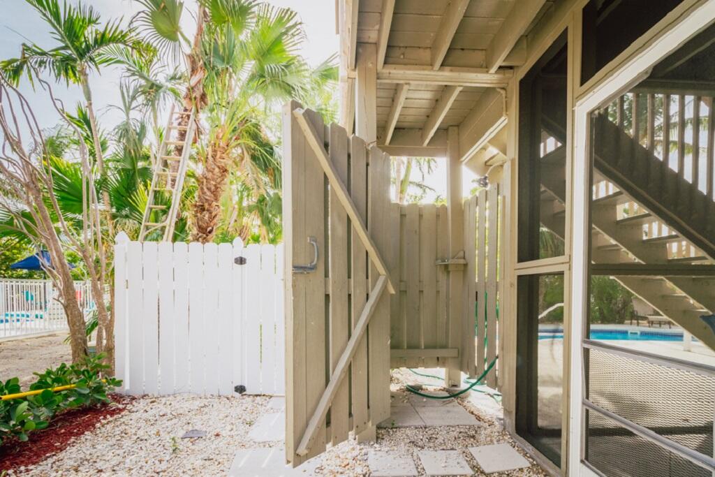 497 Sombrero Beach Road Marathon, FL 33050 - Photo 27 of 33 a view of a porch with chairs and potted plants