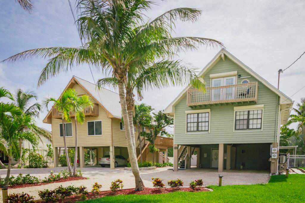 497 Sombrero Beach Road Marathon, FL 33050 - Photo 28 of 33 a view of small white house with a yard and potted plants