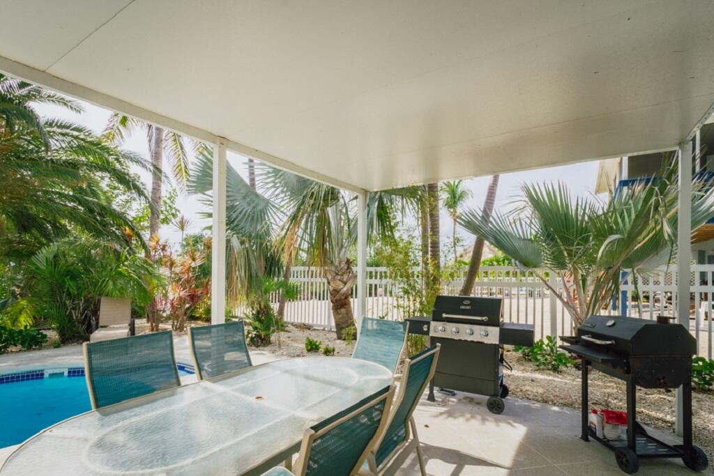 497 Sombrero Beach Road Marathon, FL 33050 - Photo 7 of 33 a outdoor living space with furniture and a potted plant
