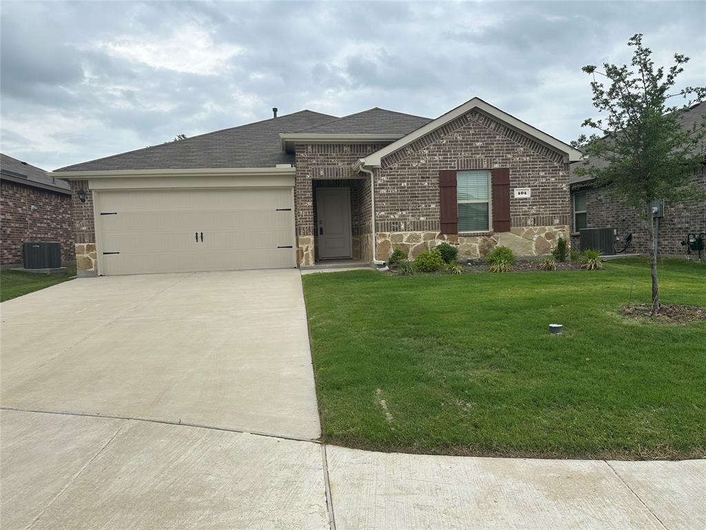 a front view of a house with a garden and yard