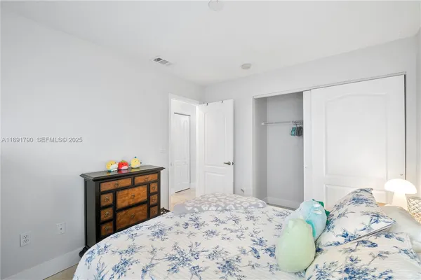 a bedroom with a bed and a dresser