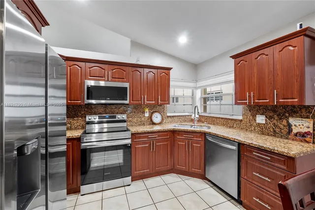 a kitchen with a sink stove and microwave